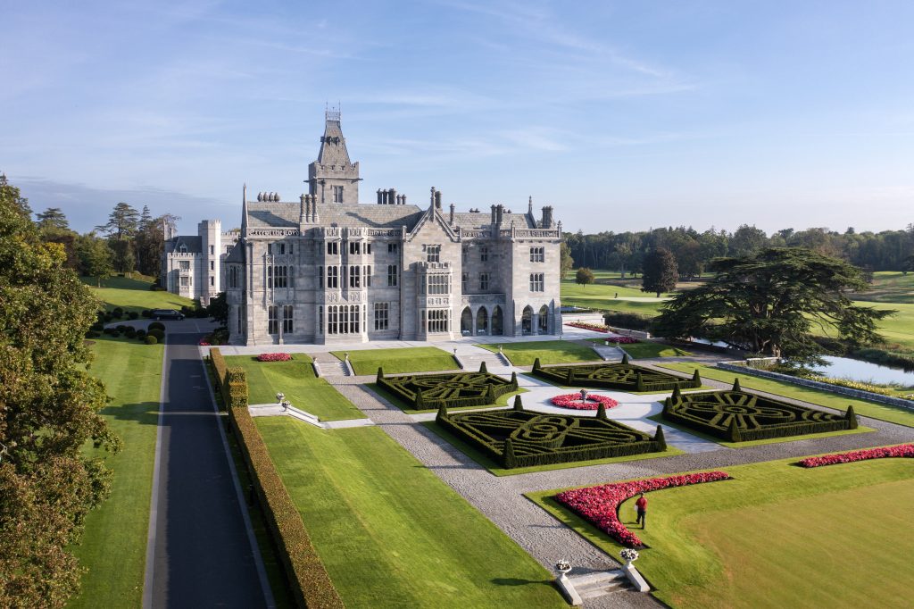 Exterior of luxury hotel Adare Manor in Ireland with gardens